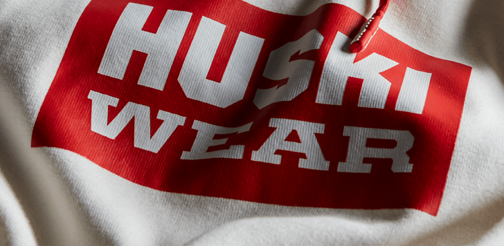 Huski Wear white hoodie with red logo.